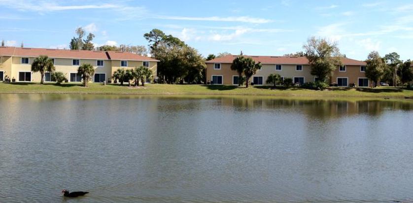 Cortez Village townhomes seen across the community lake in Fort Pierce, Florida
